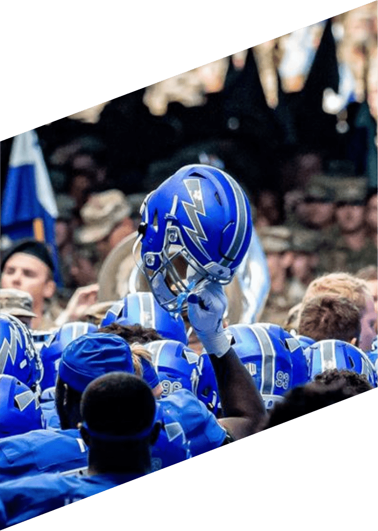 football player holding up helmet