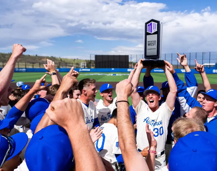 baseball players holding trophy