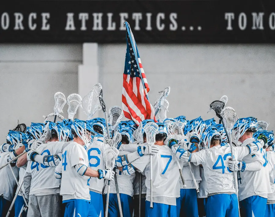 lacrosse players in a huddle