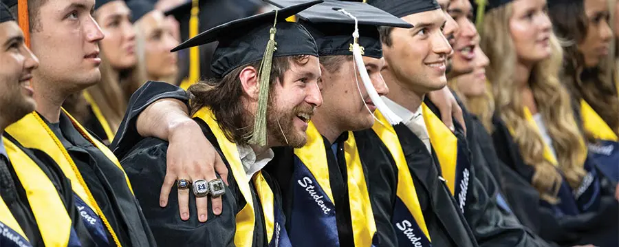 graduates smiling