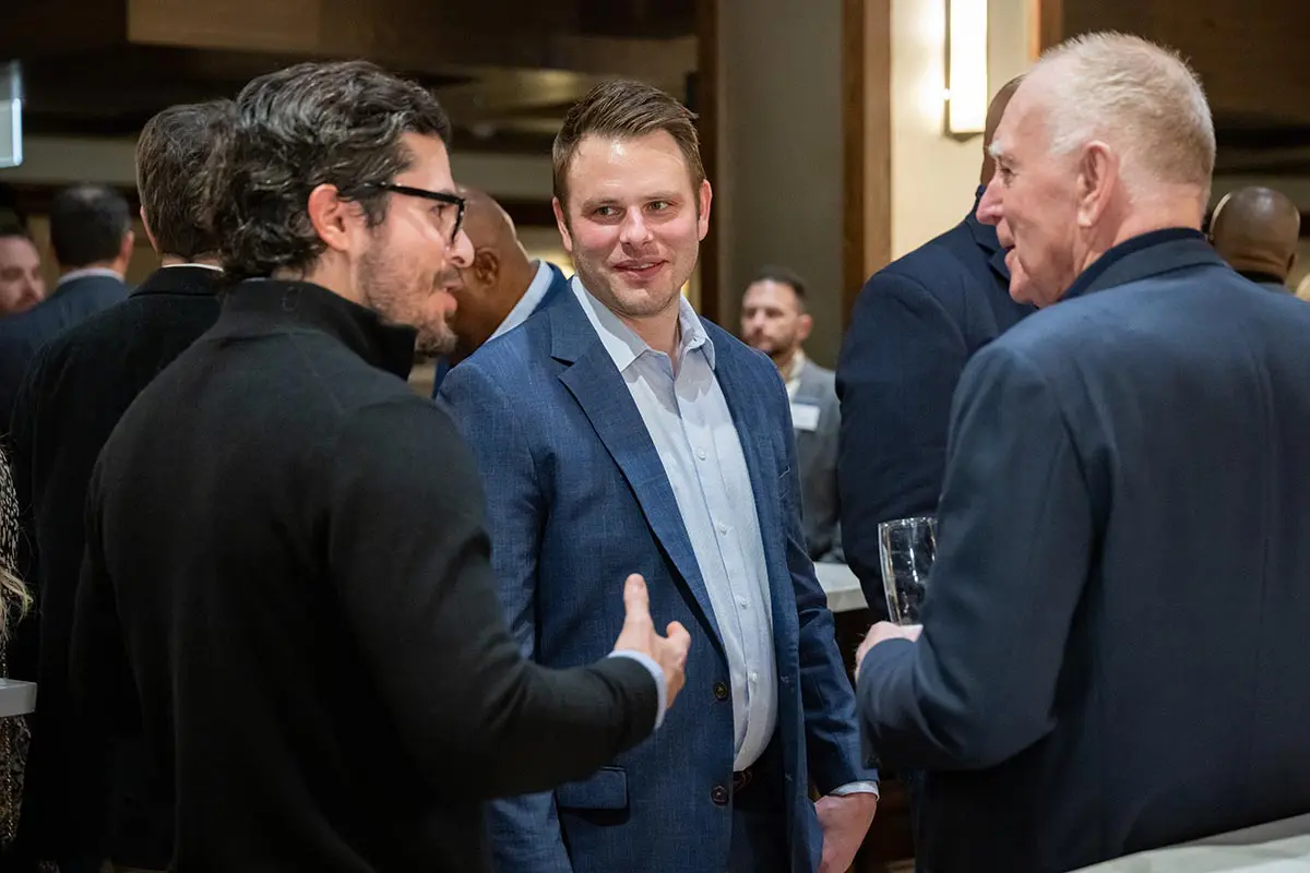 Three men talking